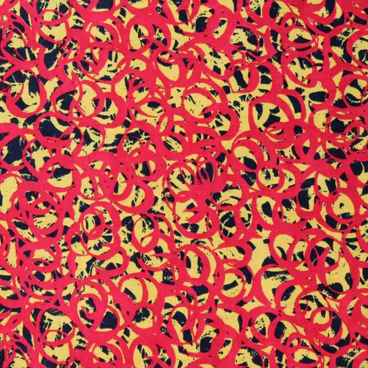 A close-up of a patterned fabric featuring overlapping red circular brushstroke motifs on a yellow background with black textured accents.