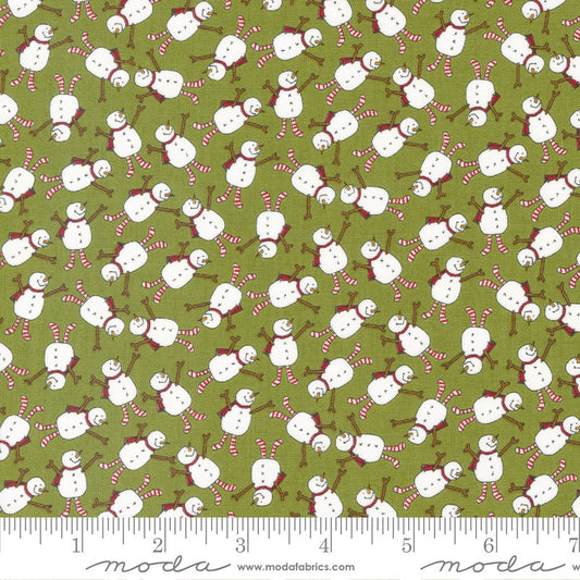 A repeating fabric pattern featuring white snowmen with red and white striped scarves and poles on an olive green background, with a measuring ruler along the bottom edge showing scale.