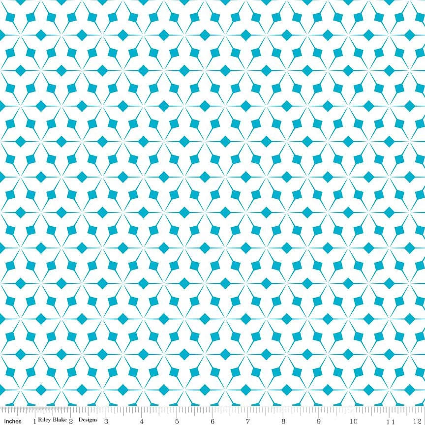 Patterned fabric with a geometric design on a beige background, featuring a ruler for scale.
