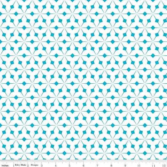 Patterned fabric with a geometric design on a beige background, featuring a ruler for scale.