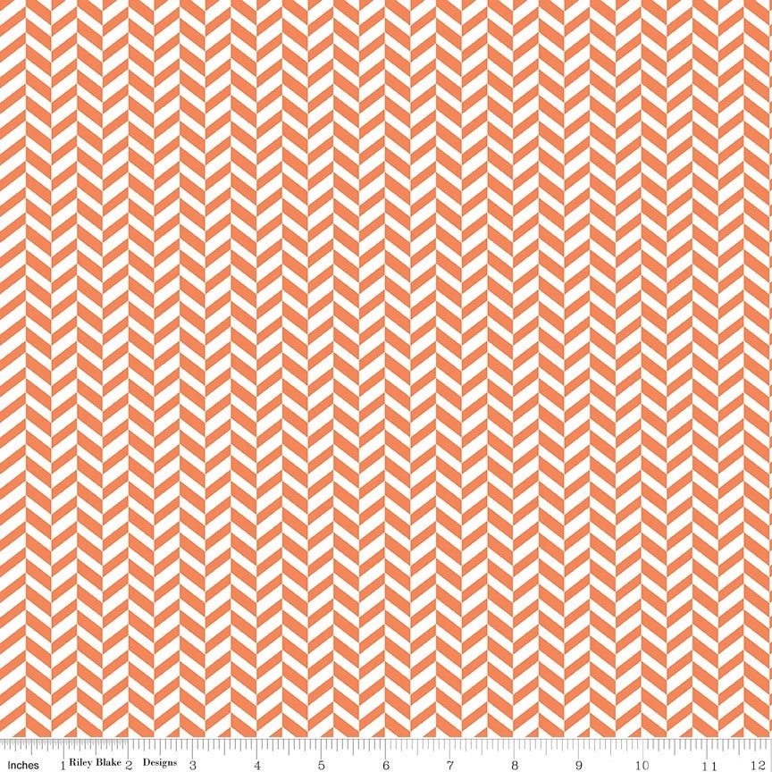 A close-up of a repeating chevron pattern in coral orange and white, with a small ruler strip along the bottom edge showing scale.