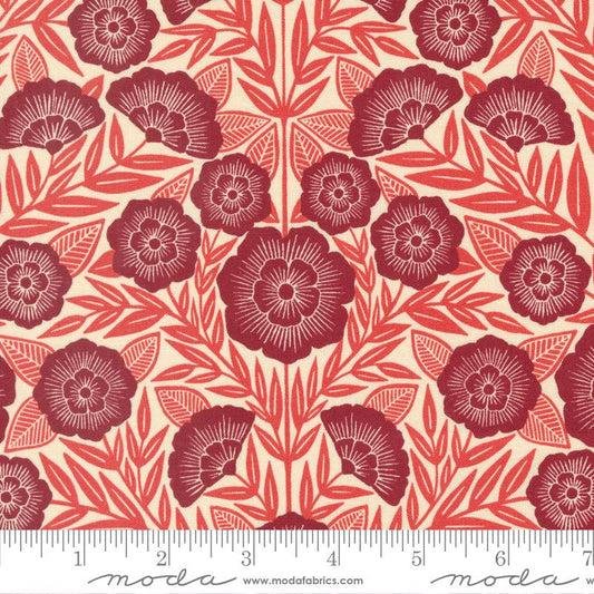 A repeating floral pattern fabric swatch featuring dark red stylized flowers and leaves on a warm cream background, with a measuring ruler along the bottom edge showing the scale.