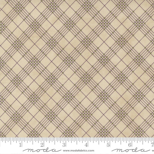Beige fabric with a brown geometric plaid pattern and a white ruler along the bottom edge showing scale.