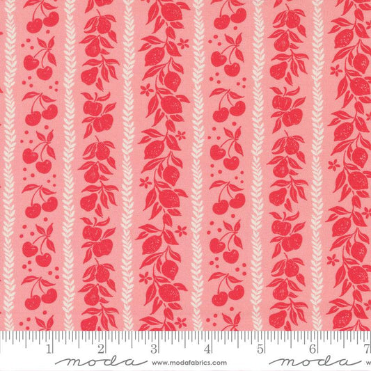 A close-up of a fabric pattern featuring vertical stripes with red cherries, apples, and wheat motifs on a light pink background, with a white ruler along the bottom edge showing measurement markings and the Moda Fabrics watermark.