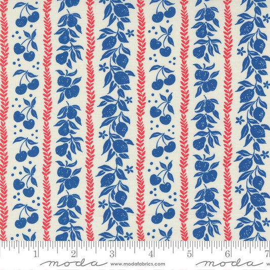 A close-up of a fabric pattern featuring vertical stripes with blue fruit and leaf motifs, red wheat-like stalks, and small blue dots on an off-white background. A ruler and the Modas fabric brand name are visible along the bottom edge.