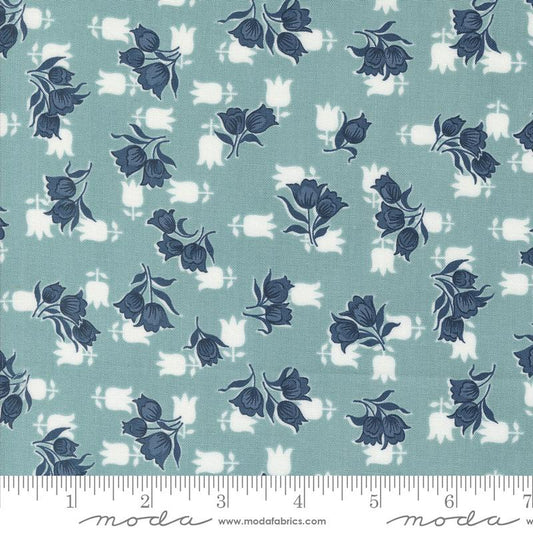 Fabric with blue floral pattern on a teal background, featuring Moda label.