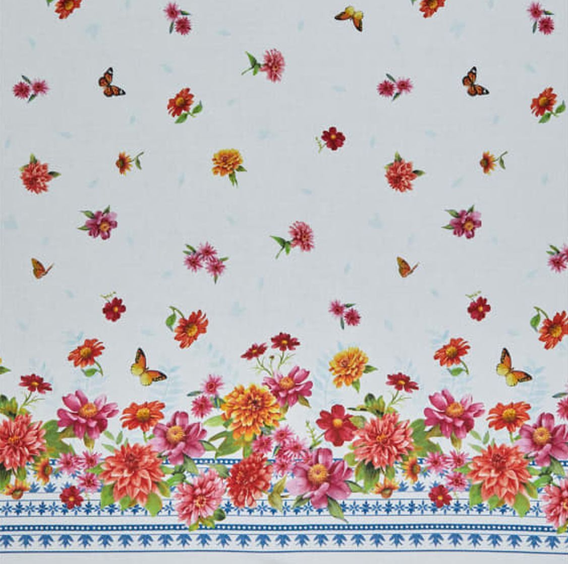 A close-up of a fabric pattern featuring a light blue background with scattered pink, red, and yellow flowers, small butterflies, and a decorative floral border along the bottom with blue geometric accents.