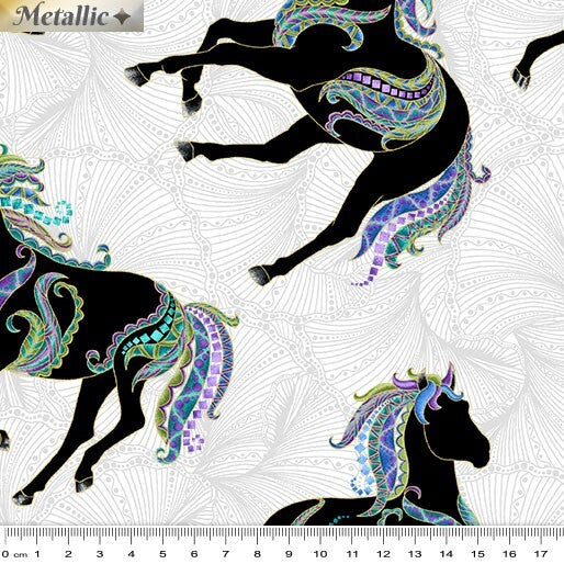 A close-up of a patterned fabric showing black stylized horses with ornate multicolor teal, purple, and gold decorative swirls on a white patterned background. A ruler scale appears along the bottom edge, and a small 'Metallic' label is visible in the top left.