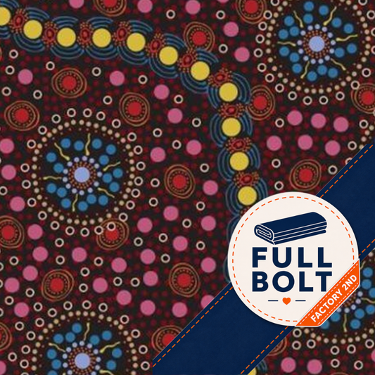 A close-up of a patterned fabric with a dark red background and circular dot motifs in blue, yellow, pink, white, and orange. A white circular badge with a navy rolled bolt icon and the text 'FULL BOLT' appears in the lower right, with a small orange diagonal banner reading 'FACTORY 2ND'.