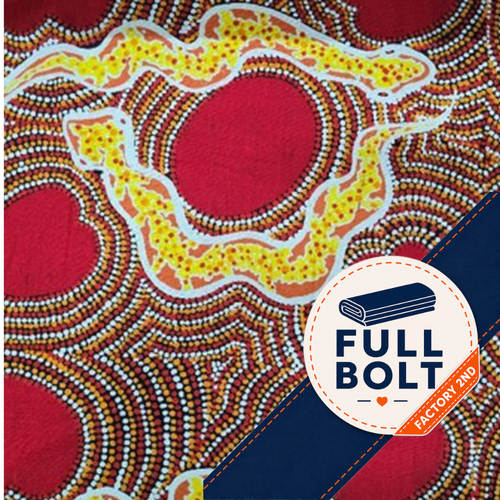 A close-up of a patterned fabric featuring Aboriginal-style dot art in red, yellow, white, brown, and orange, with a blue diagonal band and a circular 'FULL BOLT FACTORY 2ND' logo overlay.