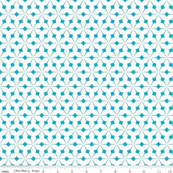 Patterned fabric with a geometric design on a beige background, featuring a ruler for scale.