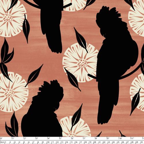 A repeating fabric featuring black cockatoo silhouettes and cream floral motifs on a warm terracotta background, with a white measurement ruler along the bottom edge.