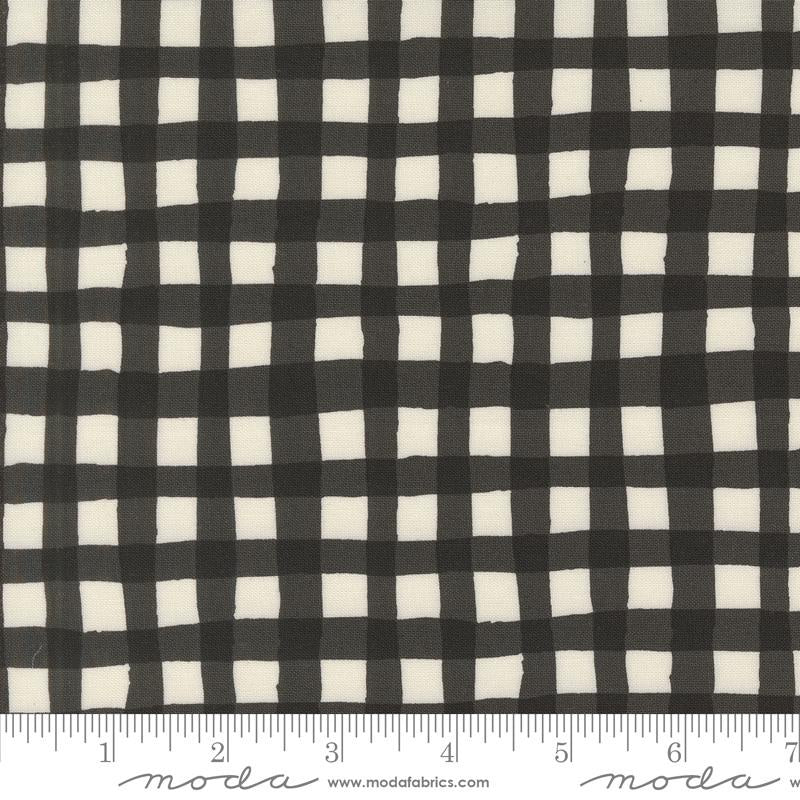 Charcoal Black and white gingham fabric pattern shown close up with a ruler at the bottom indicating scale. The brand name 'moda' is visible on the ruler watermark.