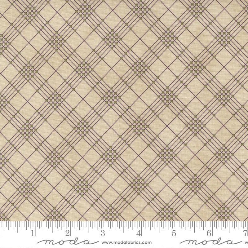 Beige fabric with a brown geometric plaid pattern and a white ruler along the bottom edge showing scale.