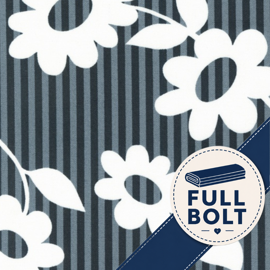 A close-up of fabric showing a navy and gray vertical stripe background with large white floral motifs. A circular badge in the lower right reads “FULL BOLT” with a folded fabric icon and a dark blue diagonal band across the corner.