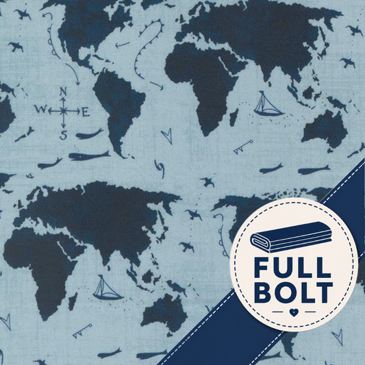 Light blue fabric with a dark navy world map print, featuring small nautical illustrations like sailboats, ships, and compass roses. A circular badge in the lower right says 'FULL BOLT' with a rolled fabric icon.