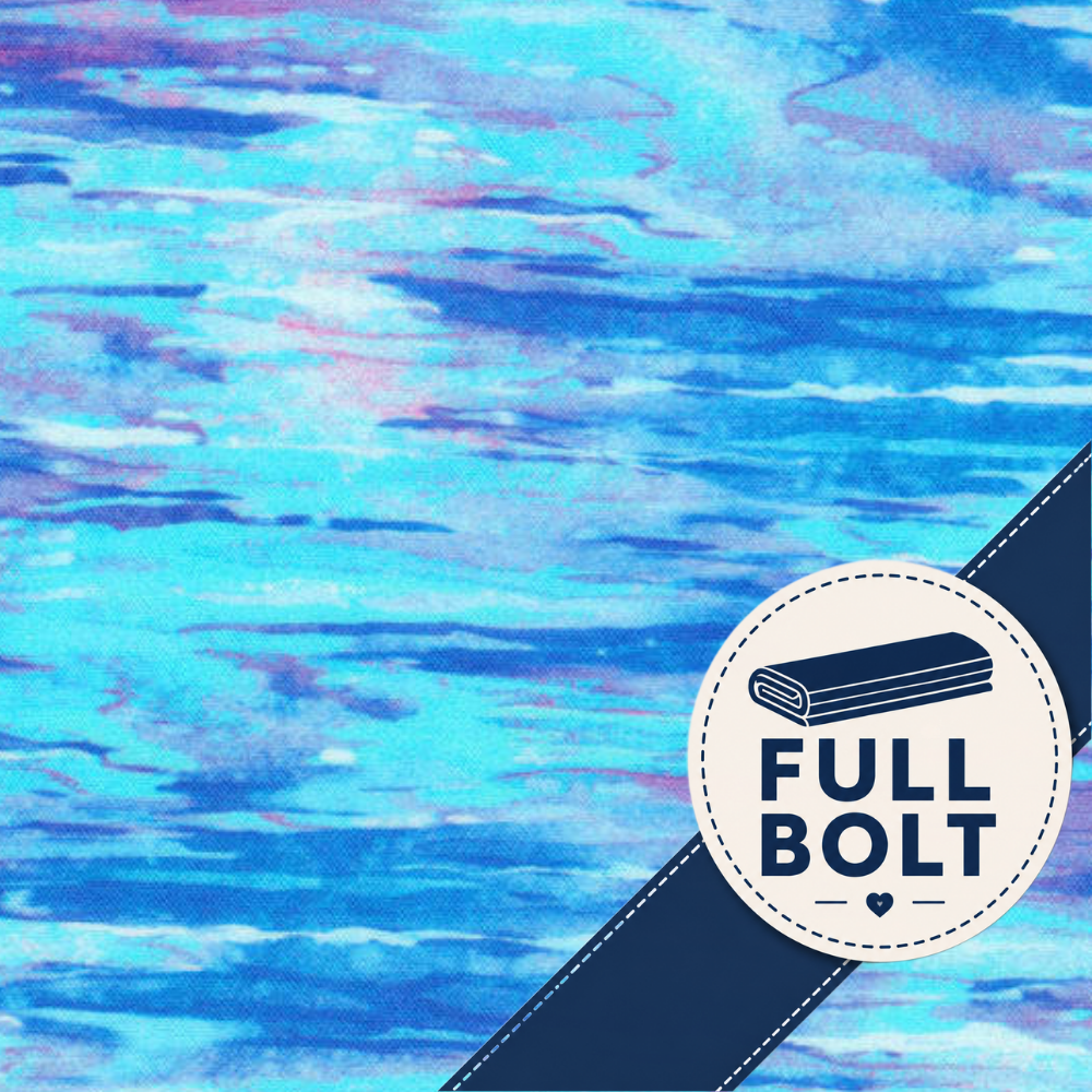 A close-up of a blue and turquoise fabric with soft pink and purple watercolor-like streaks, plus a dark navy diagonal band and a circular white badge reading FULL BOLT.