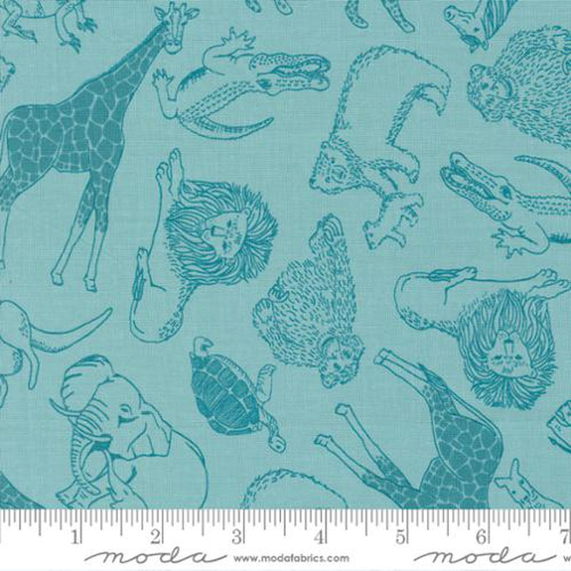 A close-up of fabric featuring a repeating pattern of animal illustrations in dark teal on a light aqua background, with a ruler strip along the bottom showing the scale of the print. The visible brand text at the bottom reads Moda.