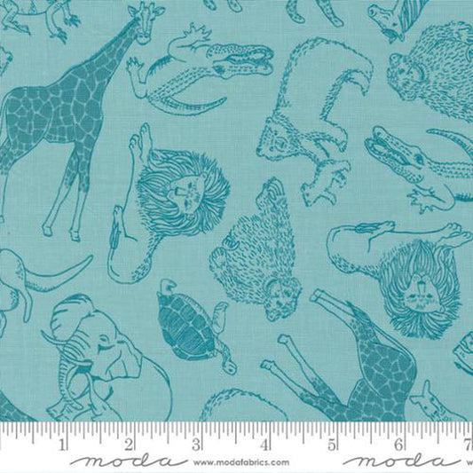 A close-up of fabric featuring a repeating pattern of animal illustrations in dark teal on a light aqua background, with a ruler strip along the bottom showing the scale of the print. The visible brand text at the bottom reads Moda.