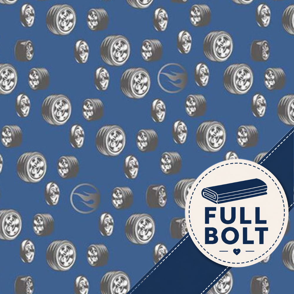 A blue patterned fabric featuring repeated silver wheels and tyres with hot wheel logo and a white circular badge with the text 'FULL BOLT' and a bolt icon.