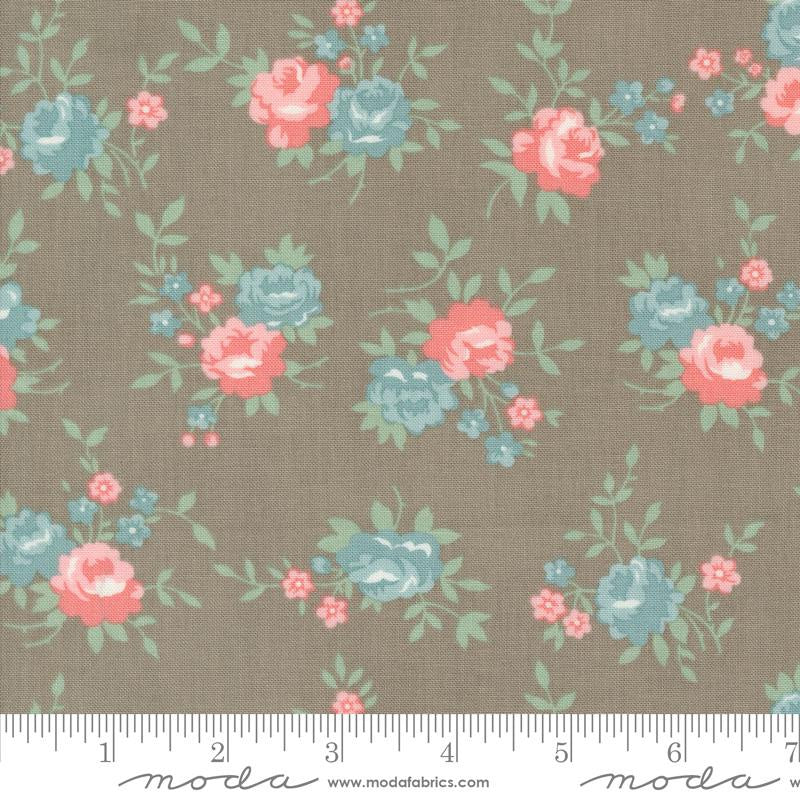 Floral fabric pattern with pink and blue flowers on a brown background, featuring Moda label.