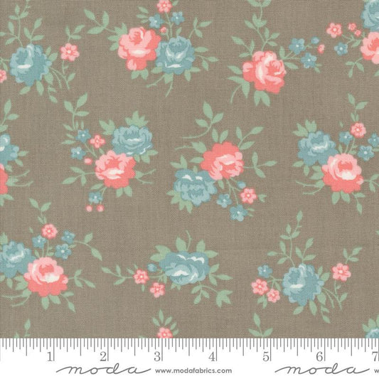 Floral fabric pattern with pink and blue flowers on a brown background, featuring Moda label.
