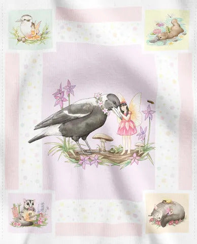 A fabric panel featuring a whimsical watercolor design. The design has a pale pink and white patchwork border with small illustrated animal and fairy scenes in the corners, surrounding a central illustration of a black and white bird standing on a log next to a fairy in a pink dress.