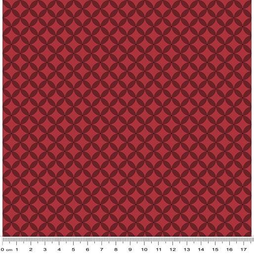 A close-up of a red fabric with a repeating dark geometric floral/starburst pattern, plus a white ruler strip along the bottom showing centimeter measurements.