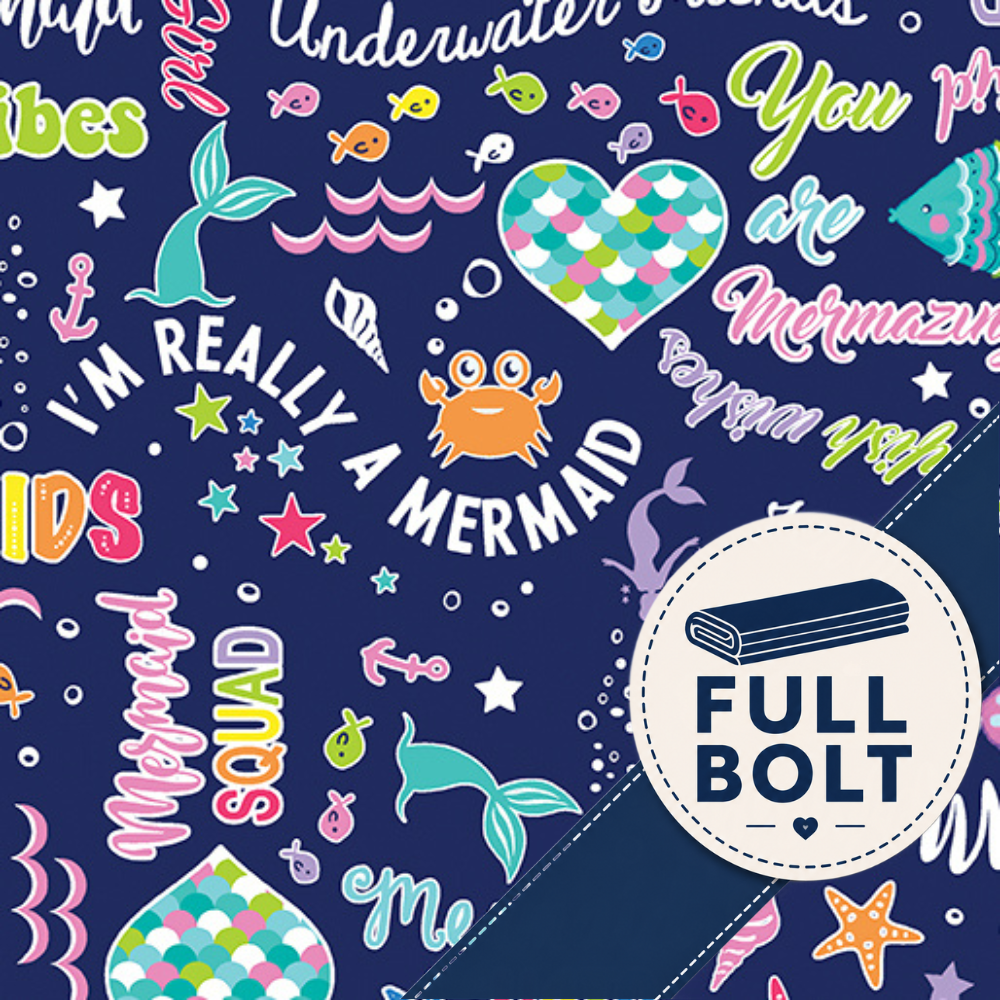 A close-up of a mermaid-themed patterned fabric featuring a navy blue background with colorful illustrations of fish, a mermaid tail, a crab, stars, and text including 'I'M REALLY A MERMAID' and a circular 'FULL BOLT' label.