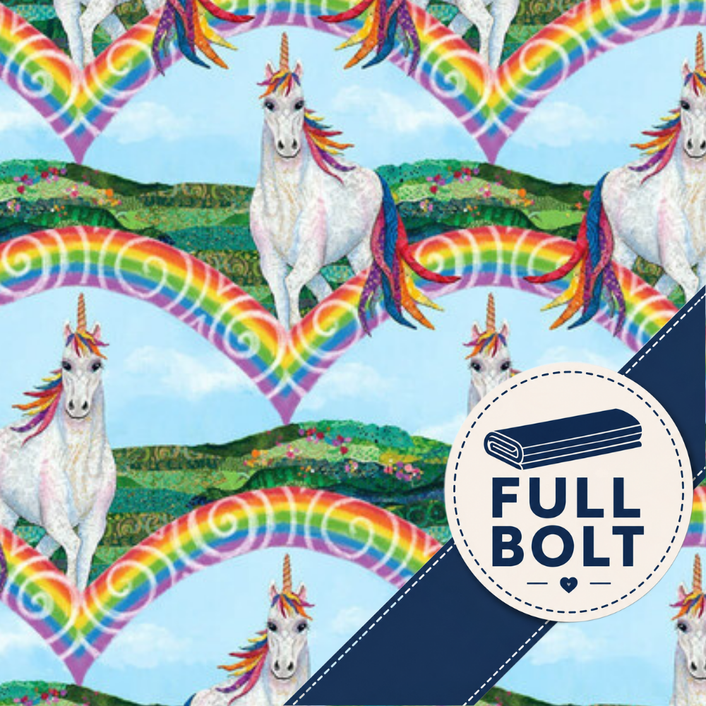 A repeating fabric pattern featuring white unicorns with rainbow manes and tails, large rainbow heart shapes, and green landscape hills on a light blue background. A dark navy diagonal banner across the lower right contains a circular badge reading “FULL BOLT” with a rolled fabric icon.