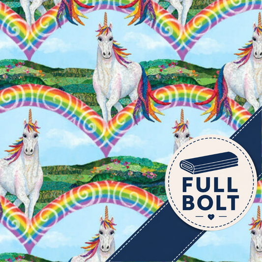 A repeating fabric pattern featuring white unicorns with rainbow manes and tails, large rainbow heart shapes, and green landscape hills on a light blue background. A dark navy diagonal banner across the lower right contains a circular badge reading “FULL BOLT” with a rolled fabric icon.
