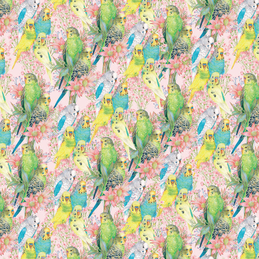 A seamless repeating fabric pattern featuring green, yellow, and blue budgerigars perched among pink flowers on a light pink background.