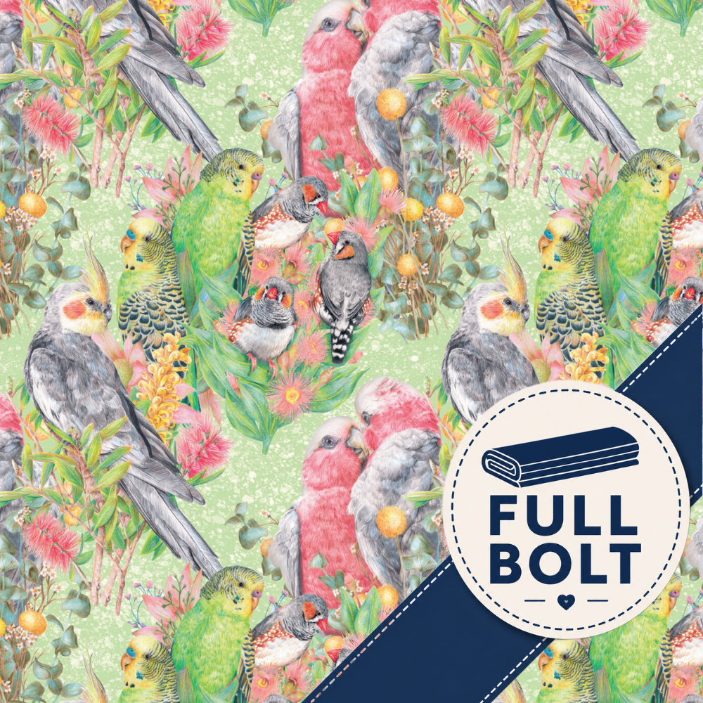 A repeating fabric pattern featuring tropical birds, including green parrots, gray cockatoos, and pink-and-white lovebirds, surrounded by pink flowers and yellow-orange berries on a light green background.