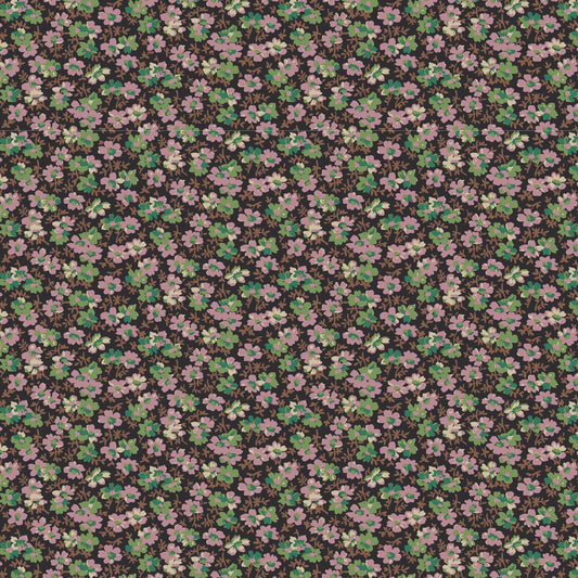 A close-up of a repeating floral fabric pattern featuring small pink and white blossoms with green leaves on a dark brown background.