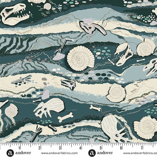 Fabric pattern with prehistoric-themed dinosaur design featuring bones and fossils on a blue and green background, with a ruler for scale.