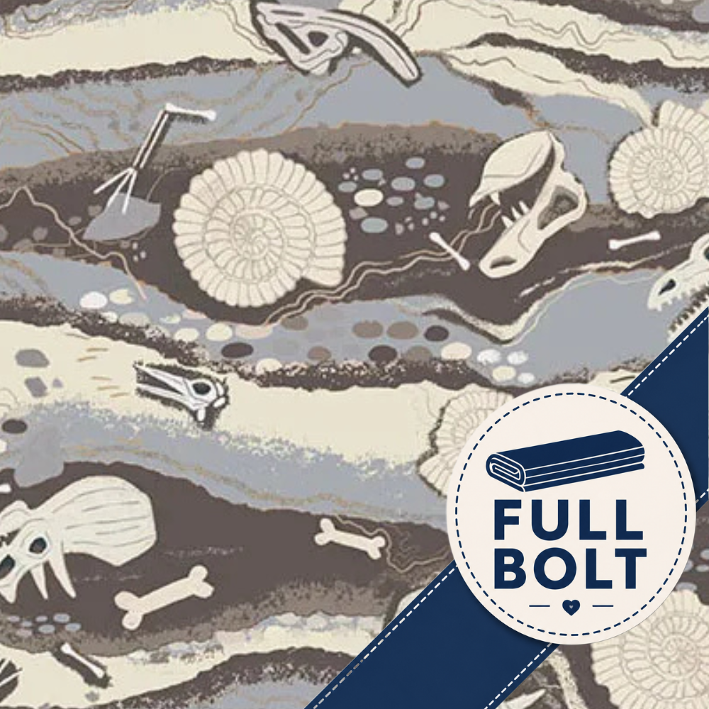 A close-up of a patterned fabric with pale beige, gray, and brown rock-like bands and illustrated fossils and bones and dinosaur skulls . A white circular badge with a blue diagonal ribbon reads “FULL BOLT.