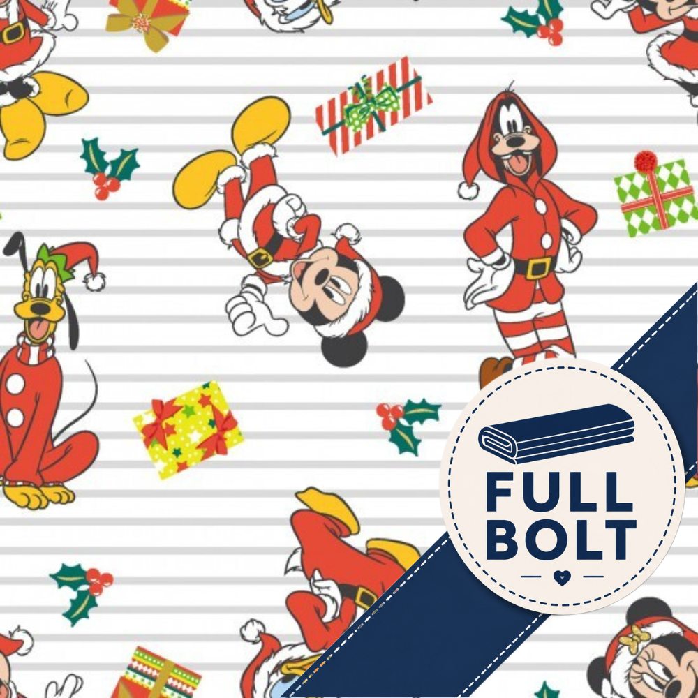 A close-up of a repeating Christmas-themed fabic featuring Mickey Mouse and Pluto in Santa outfits, holly, wrapped gifts, and a dark blue diagonal banner with a circular badge reading 'FULL BOLT'.