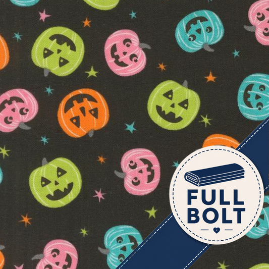 A close-up of a fabric pattern featuring colorful jack-o'-lantern pumpkins and small stars on a dark background, with a white circular badge in the lower right that reads 'FULL BOLT' over a blue diagonal stripe.