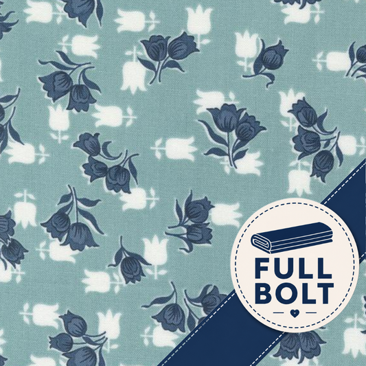 A close-up of fabric with a repeating floral print on a muted blue-green background, featuring dark blue flower motifs and white tulip silhouettes. A circular badge in the lower right says FULL BOLT with a rolled fabric icon and a dark blue diagonal stripe across the corner.