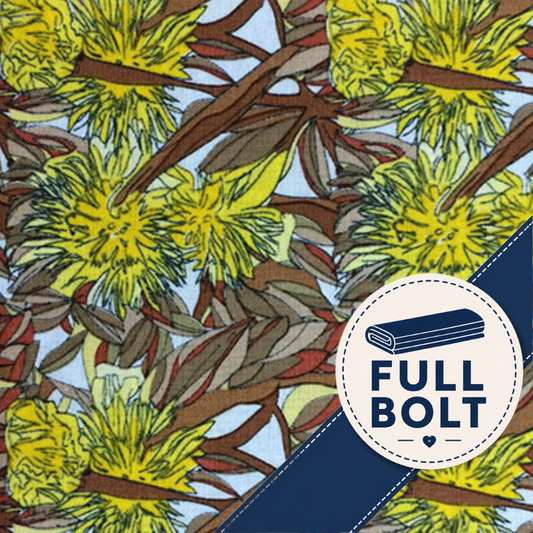 A close-up of a printed fabric or wallpaper pattern featuring bright yellow flowers, brown branches, and muted green leaves on a pale blue background, with a circular 'FULL BOLT' badge overlaid in the lower right.