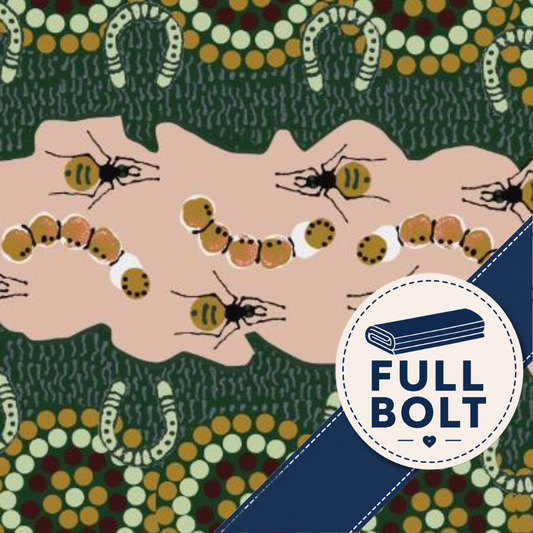 A close-up of patterned fabric with a pink central band showing illustrated ants and caterpillars, surrounded by a dark green and multicolor dotted border with horseshoe motifs. A white circular badge with a blue diagonal stripe reads 'FULL BOLT' and includes an icon of folded fabric.