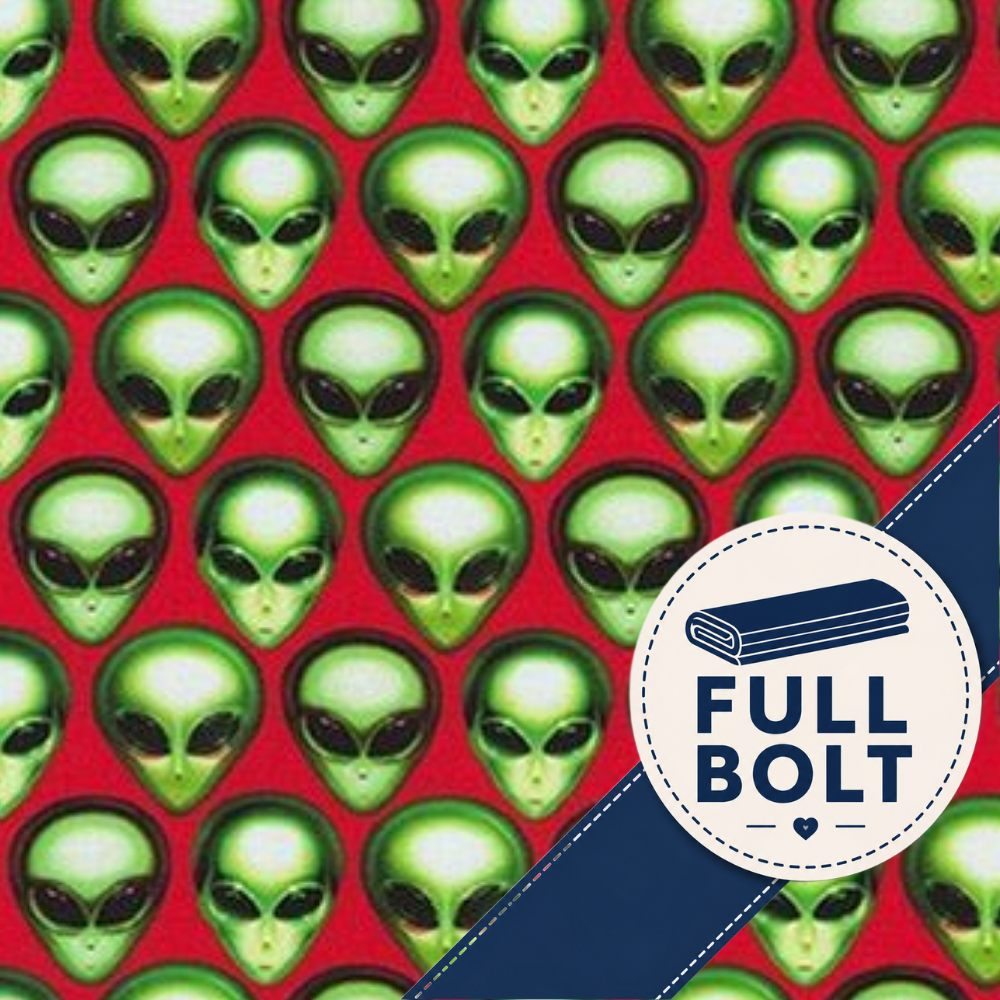 Red fabric with a repeating pattern of green alien heads, plus a white circular badge with a navy rolled item and the text 'FULL BOLT' over a navy diagonal stripe.